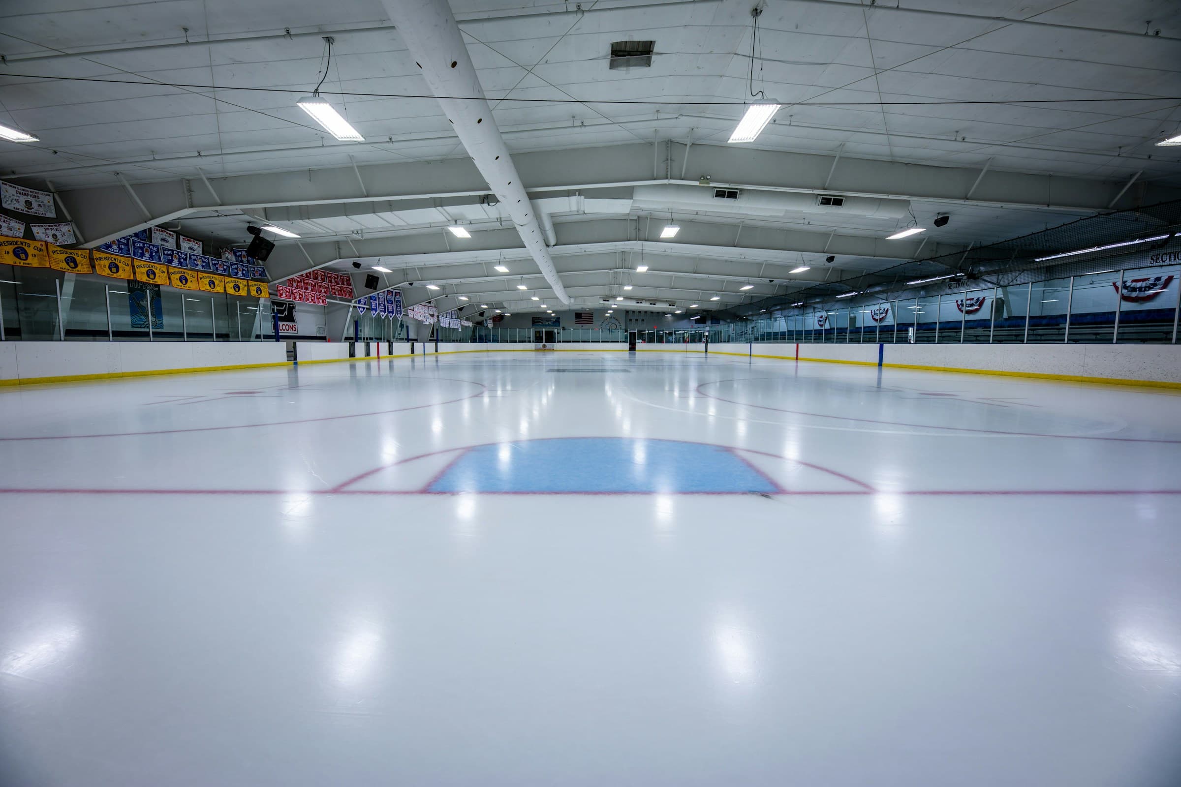 Indoor ice rink with a hockey goal. Photo by Chris DeSort on Unsplash.